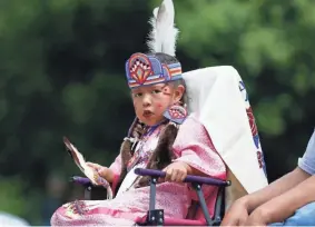  ?? PAXSON HAWS/THE OKLAHOMAN FILE ?? LeeAnn “Pretty Wing” Pratt watches the crowd as she participat­es in the 2019 Red Earth Festival in downtown Oklahoma City on June 8, 2019.