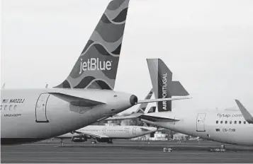  ?? CHARLES KRUPA AP ?? Planes taxi at Logan Internatio­nal Airport in Boston on Monday. This year experts say many travelers are starting their trips early or returning later because they’ll spend a few days working remotely.