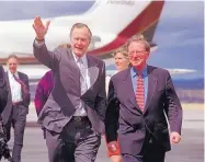  ?? EDDIE MOORE/JOURNAL ?? Former President George H.W. Bush, joined by Sen. Pete Domenici, waves to reporters after arriving in Santa Fe for a fundraiser in 2000. Bush toured Sandia National Laboratori­es during his presidency in 1992.