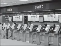  ?? [CHRIS O'MEARA/ ASSOCIATED PRESS FILE PHOTO] ?? Empty United Airlines ticket machines are shown April 24 at the Tampa Internatio­nal Airport in Tampa, Fla.