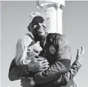  ?? MARIO TAMA/GETTY ?? Former NFL star Michael Strahan hugs Laura Shepard Churchley, daughter of astronaut Alan Shepard, Saturday after their space flight from West Texas.