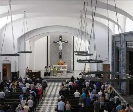  ?? ?? Msgr. Oscar CastaÃ±eda, center, conducts Latin mass facing the large cross inside Our Lady of Belen Chapel as the service attracted young worshipers and families on July 30.