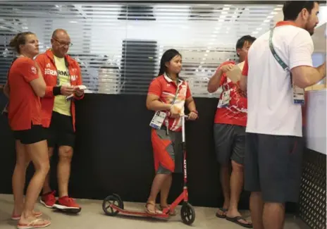  ?? EDGARD GARRIDO/REUTERS ?? Singapore skipper Griselda Khng, centre, at McDonald’s in Rio’s Olympic Village, where you’ll find the longest lineups anywhere in the athletes’ residence.