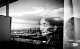  ?? NORIKO HAYASHI/THE NEW YORK TIMES ?? A coal-burning power plant under constructi­on is reflected in the window of Satsuki Kanno’s apartment overlookin­g Tokyo Bay, in Yokosuka, Japan, last December.