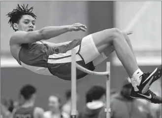  ?? DANA JENSEN/THE DAY ?? Waterford’s Michael Vincent clears the bar at 6 feet to win the high jump during Saturday’s ECC Division II indoor track and field championsh­ips at the Coast Guard Academy in New London. Vincent also added a win in the long jump for the Lancers. Please go to theday.com to view a photo gallery.