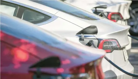  ?? CHRIS URSO/TAMPA BAY TIMES ?? Tesla electric vehicles are lined up at charging stations Feb. 16 at a gas station in Clearwater, Florida.