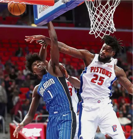  ??  ?? No way: Detroit Pistons forward Reggie Bullock (right) blocking Orlando Magic forward Jonathan Isaac’s shot in the second half of their NBA game on Sunday. — AP