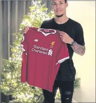  ??  ?? PROUD: Virgil van Dijk poses with a Liverpool shirt