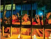  ?? PTI ?? Homeless people light candles at a shelter home in New Delhi on Sunday