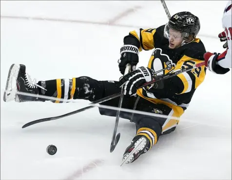  ?? Peter Diana/Post-Gazette photos ?? Jake Guentzel is tripped by Washington’s Garnet Hathaway Tuesday night in the Penguins 5-4, come-from-behind victory at PPG Paints Arena.