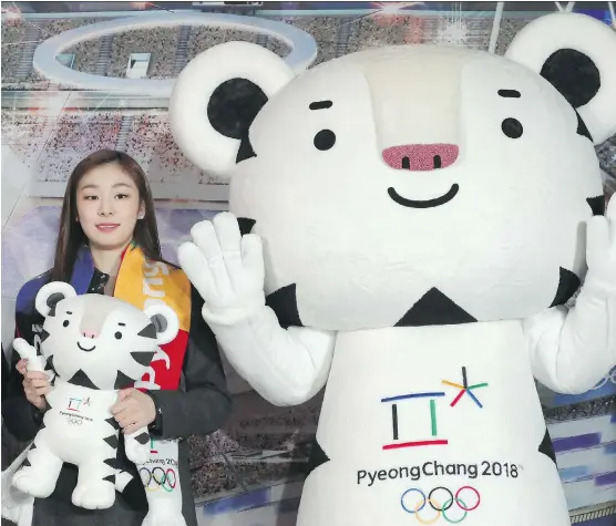  ?? AP PHOTO/LEE JIN-MAN, FILE ?? Figure skating Olympic gold medallist Yuna Kim, pictured in February, an honorary ambassador for the 2018 Winter Olympics, poses with an official mascot of the PyeongChan­g Games, white tiger Soohorang. With five months to go before the Winter Olympics...