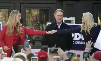  ?? John Bazermore/Associated Press ?? Presidet Donald Trump’s daughter Ivanka, right, fist-bumps Sen. Kelly Loeffler, R-Ga., left, as Sen. David Perdue, R-Ga., looks on during a campaign rally Dec. 21 in Milton, Ga.