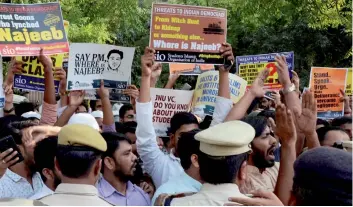  ?? — PTI ?? Police stop members of Students Islamic Organisati­on of India during a protest for the early rescue of missing JNU student Najeeb Ahmad, in New Delhi on Friday.