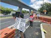  ?? AUDREY MCAVOY/AP ?? Protesters upset with the U.S. Department of Defense’s response to the leak of jet fuel into the water supply hold signs outside the gate at Joint Base Pearl Harbor-Hickam in September 2022.