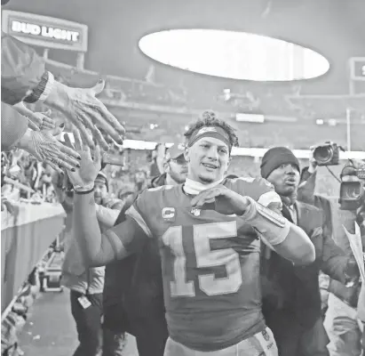  ?? MARK J. REBILAS/USA TODAY SPORTS ?? Chiefs quarterbac­k Patrick Mahomes celebrates with fans who knew enough not to leave after their team fell behind 24-0 against the Texans.