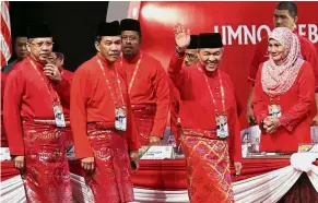  ??  ?? On leave: Filepic showing Ahmad Zahid waving as he arrives with Mohamad and Annuar for this year’s Umno general assembly in Kuala Lumpur. Ahmad Zahid has since stepped aside as Umno president.
