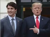  ?? SEAN KILPATRICK, THE CANADIAN PRESS ?? Prime Minister Justin Trudeau is greeted by U.S. President Donald Trump as he arrives at the White House in Washington, D.C., last October. Tim Harper argues it is wrong to attempt to stop Trump from visiting Canada.