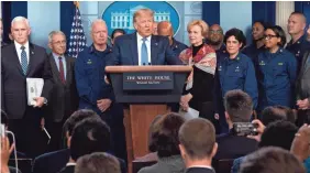  ?? JIM WATSON/AFP VIA GETTY IMAGES ?? President Donald Trump, with members of the Coronaviru­s Task Force, speaks at a news briefing at the White House on Sunday.