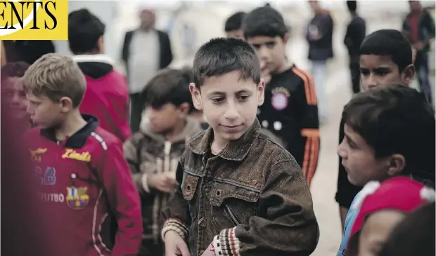  ?? PHOTOS: MAYA ALLERUZZO / THE ASSOCIATED PRESS ?? Akram Rasho Khalaf, 10, is pictured with other children on Friday at the Kabarto Camp for internally displaced people in Dahuk, Iraq. Akram was captured, trained and sold into servitude by ISIL militants when he was seven. He suffers from nightmares...