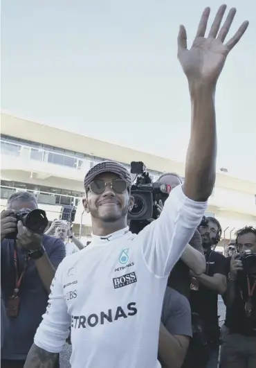  ??  ?? 0 Lewis Hamilton waves to the crowd after winning the US Grand Prix in Texas on Sunday.