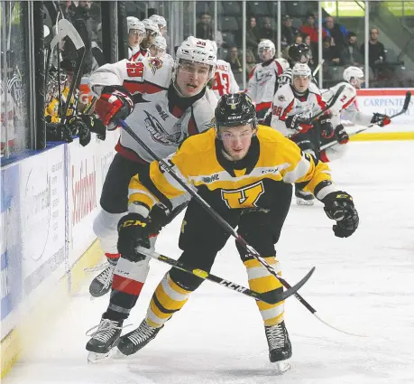  ?? IAN MACALPINE ?? Kingston Frontenacs defenceman Evan Brand gets in front of the Spitfires Curtis Douglas Friday at the Leon’s Centre in Kingston.