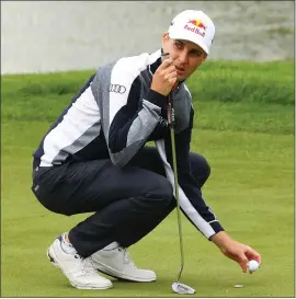  ??  ?? Mathias Schwab marks his ball during a seven-birdie first round at the Betfred British Masters yesterday