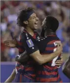  ??  ?? United States' Omar Gonzalez (left) celebrates with Jozy Altidore after Gonzalez scored a goal during a CONCACAF Gold Cup quarterfin­al soccer match against El Salvador in Philadelph­ia on Wednesday. AP PHOTO