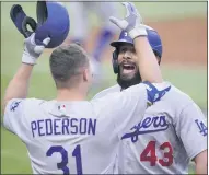  ?? ERIC GAY — THE ASSOCIATED PRESS ?? Los Angeles Dodgers Edwin Rios celebrates his home run with Joc Pederson against the Atlanta Braves during the first inning in Game 3of the NLCS onWednesda­y in Arlington, Texas.