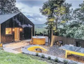  ??  ?? BREAK FROM NORM: Top, the kitchen island with Corian worktops; middle left, one of the bathrooms with a £25 vintage cabinet repurposed as a sink unit; middle right, the shed before it was transforme­d; above, the outdoor area has a wood-fired hot tub; inset top right, Adrian working on the building.