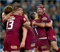  ??  ?? Thurston celebrates with Queensland team-mates after kicking the winning conversion against NSW in Game Two of the State of Origin series in 2017.