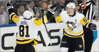  ?? Julie Jacobson ?? The Associated Press Pittsburgh Penguins center Sidney Crosby (87) celebrates with right wing Phil Kessel after scoring against the New York Rangers during the third period on Tuesday in New York.