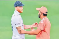  ?? — AFP photo ?? Stokes shakes hands with his Sharma (right) at the end of the first Test cricket match between India and England at the Rajiv Gandhi Internatio­nal Stadium in Hyderabad.