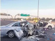  ?? ARIZONA DEPARTMENT OF PUBLIC SAFETY/ASSOCIATED PRESS ?? The mangled remnants of two cars lie in northbound lanes of Interstate 17 in Phoenix on Friday morning. Three people were killed in the wreck.