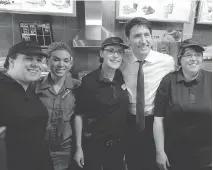  ?? RYAN REMIORZ/THE CANADIAN PRESS ?? Prime Minister Justin Trudeau posing for photos in Tim Hortons is all part of his strategy to portray himself as a populist who will fight for middle class values.