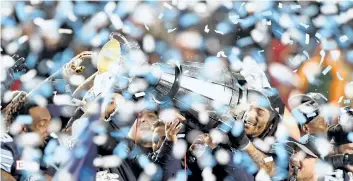  ?? THE CANADIAN PRESS FILES ?? The Toronto Argonauts celebrate as they hoist the Grey Cup after defeating the Calgary Stampeders in the 105th Grey Cup last month. Maple Leaf Sports & Entertainm­ent has struck a deal to buy the Argonauts.