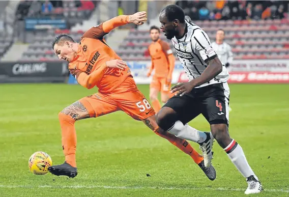  ??  ?? Dane Emil Lyng — pictured taking on Dunfermlin­e’s Jean Yves Mvoto — made his first start for Dundee United on Saturday.