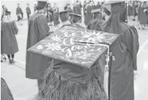  ?? Gillian Jones / Berkshire Eagle ?? Massachuse­tts College of Liberal Arts graduate Kayla LaVoice wears a painted mortar board during commenceme­nt Saturday in North Adams, Mass.