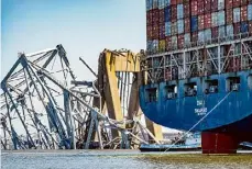  ?? Jerry Jackson/Tribune News Service ?? The wreckage of the Francis Scott Key Bridge is seen beyond the stern of the container ship Dali three weeks after the catastroph­ic collapse. A third temporary channel for boats to enter and depart the Port of Baltimore has opened to “commercial­ly essential vessels,” port officials announced Friday.