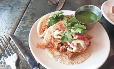  ?? DOMINIC ARMATO/THE REPUBLIC ?? Pollo tacos with cilantro, pickled red onion, cilantro crema and salsa verde at Roland’s Cafe Market Bar in Phoenix.