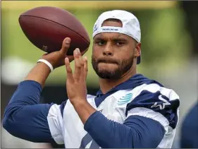  ??  ?? In this July 26, file photo, Dallas Cowboys quarterbac­k Dak Prescott throws a pass during NFL football training camp in Oxnard, Calif. AP PHOTO/GUS RUELAS