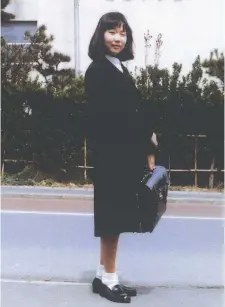  ??  ?? Megumi Yokota outside her school in Niigata, Japan, in April 1977. The photo was taken by her father, who still believes she is alive despite claims by the North Korean government that she committed suicide.