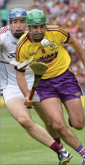  ??  ?? Wexford sweeper Shaun Murphy racing out of defence with Galway’s man of the match Conor Cooney in hot pursuit.