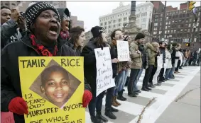  ?? TONY DEJAK — THE ASSOCIATED PRESS FILE ?? In this Nov. 25, 2014, file photo, demonstrat­ors block Public Square in Cleveland, during a protest over the police shooting of 12-year-old Tamir Rice. Tamir was playing with a toy gun when Cleveland police responding to a call pulled up and within seconds, shot him. When his 14-old-sister ran to the scene, she was pushed to the ground and handcuffed. The officers were not indicted.