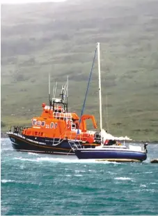  ??  ?? Left: a lazy day on Loch Crinan. Below: rescue by the Mallaig lifeboat during another adventure