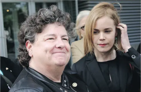  ?? COLIN PERKEL / THE CANADIAN PRESS ?? Retired RCMP officer Linda Davidson, left, and her lawyer Megan McPhee react to the discrimina­tion award.