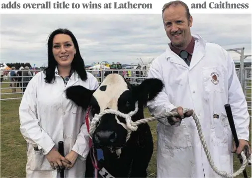  ??  ?? TOP OF THE TOPS: Mark and Debby Munro, Invercharr­on Farm, Ardgay, with supreme cattle champion British Blue heifer Kiss My . . .