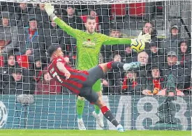  ??  ?? Bournemout­h’s Joshua King scores against Manchester United.