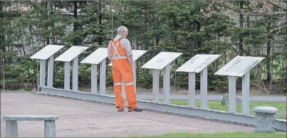  ?? $1 1)050 ?? A worker reads the explanator­y plaques as he attends a service to honour the 26 coal miners who perished in the Westray Mine disaster at the Westray Miners Memorial Park in New Glasgow on Tuesday. The coal mine exploded 25 years ago to the day on May...