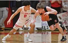  ?? CHRIS CHRISTO — BOSTON HERALD ?? St. Sebastian’s Trevor Mullin is defended by St. Paul’s Carey Logan. St. Sebastian’s won 72-52 and Mullin now has 1,989 career points.