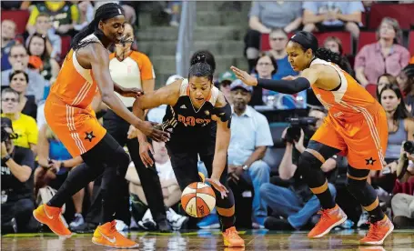  ?? ELAINE THOMPSON/AP PHOTO ?? The Eastern Conference’s Alyssa Thomas, center, of the Connecticu­t Sun, dribbles between the Western Conference’s Sylvia Fowles, left, and Maya Moore, both of the Minnesota Lynx, during the West’s 130-121 win in Saturday’s WNBA All-Star Game in Seattle.